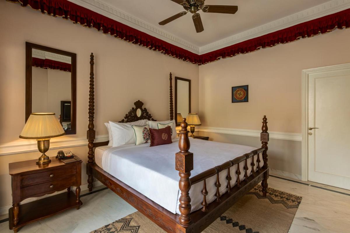 a bedroom with a bed and a ceiling fan at Raajkutir - IHCL SeleQtions in Kolkata