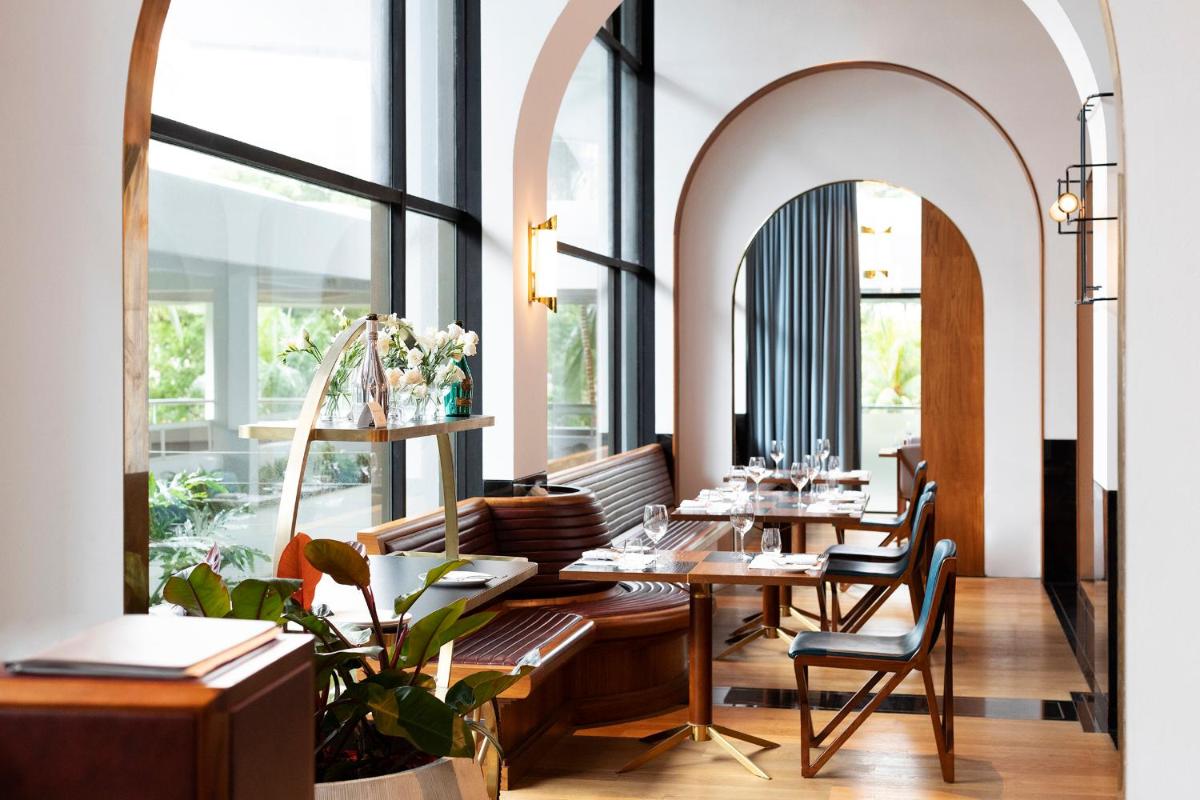 a restaurant with tables and chairs and windows at Shangri-La Singapore in Singapore