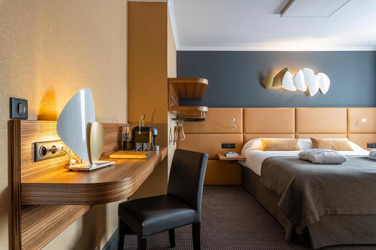 Un ou plusieurs lits dans un hébergement de l'établissement Hotel Residence Europe & Spa