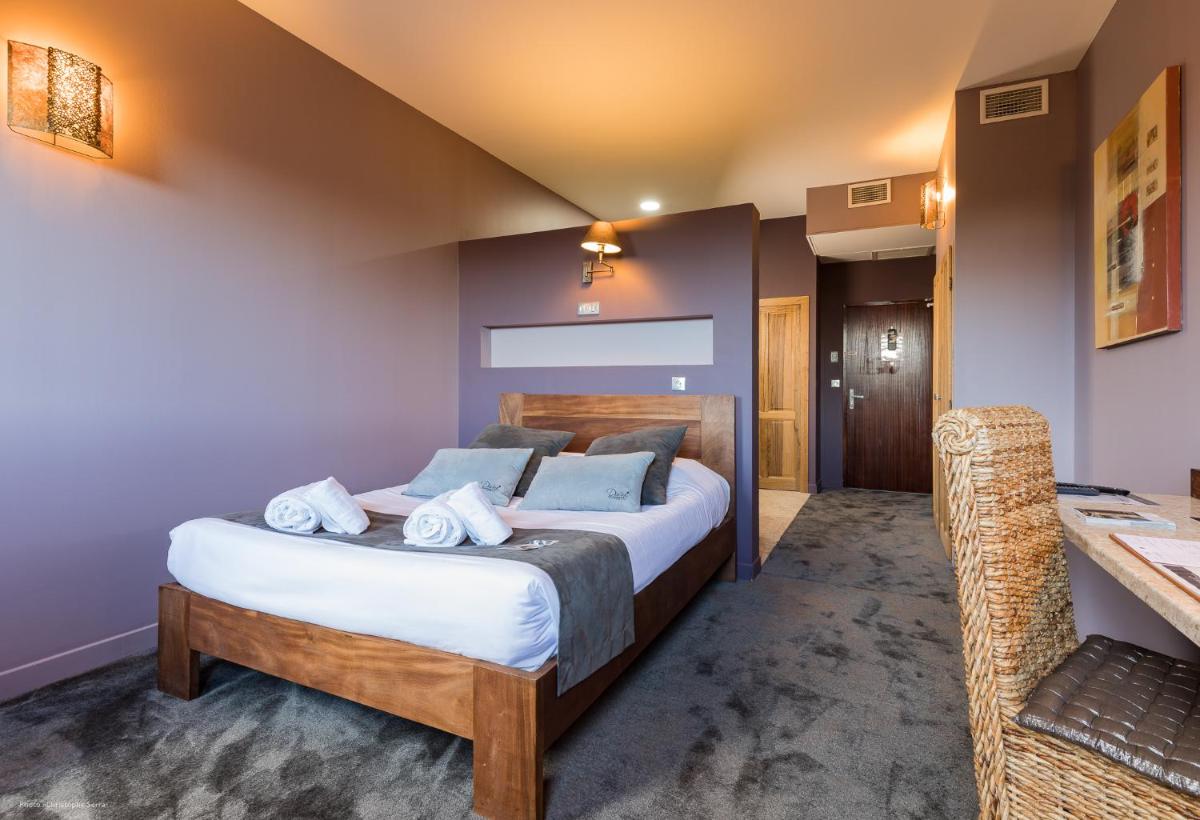 Un ou plusieurs lits dans un hébergement de l'établissement Hotel restaurant Spa Disini Montpellier Est, The Originals Relais