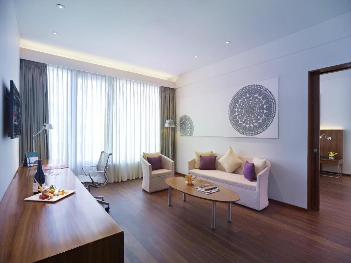 a living room with a couch and a table at Vivanta Chennai IT Expressway OMR in Chennai