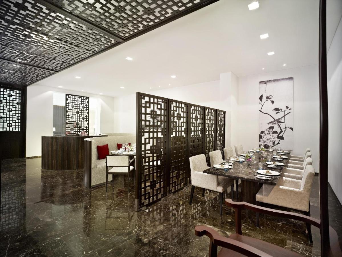 a dining room with a table and chairs at Vivanta Chennai IT Expressway OMR in Chennai