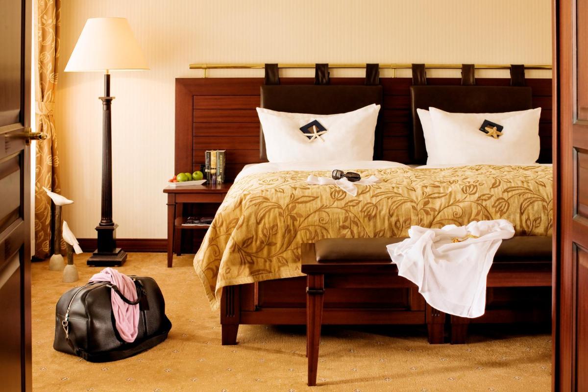 Ein Bett oder Betten in einem Zimmer der Unterkunft Yachthafenresidenz Hohe Düne