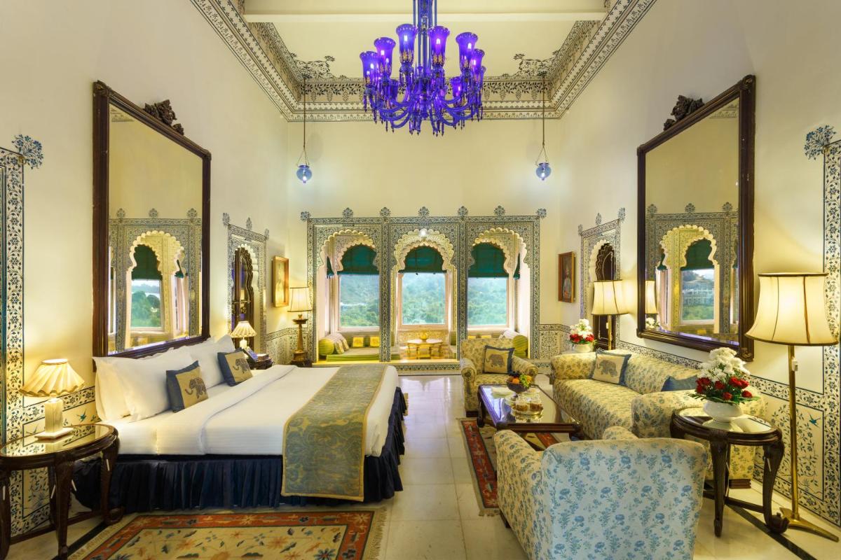 a bedroom with a bed and a couch at Shiv Niwas Palace by HRH Group of Hotels in Udaipur