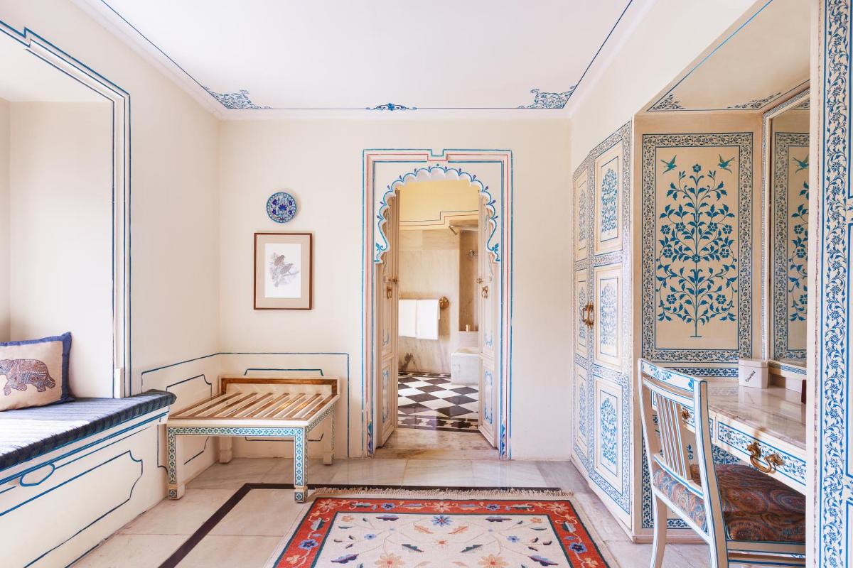 a room with a hallway with a door and a rug at Shiv Niwas Palace by HRH Group of Hotels in Udaipur