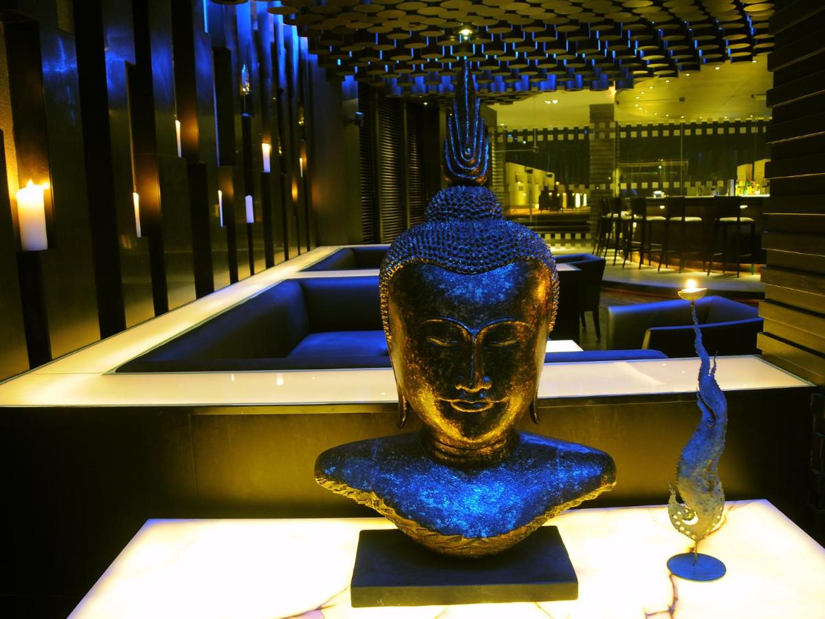 a vase sitting on a table in a room at The Lalit Ashok in Bengaluru a vase sitting on a table in a room at The Lalit Ashok in Bengaluru