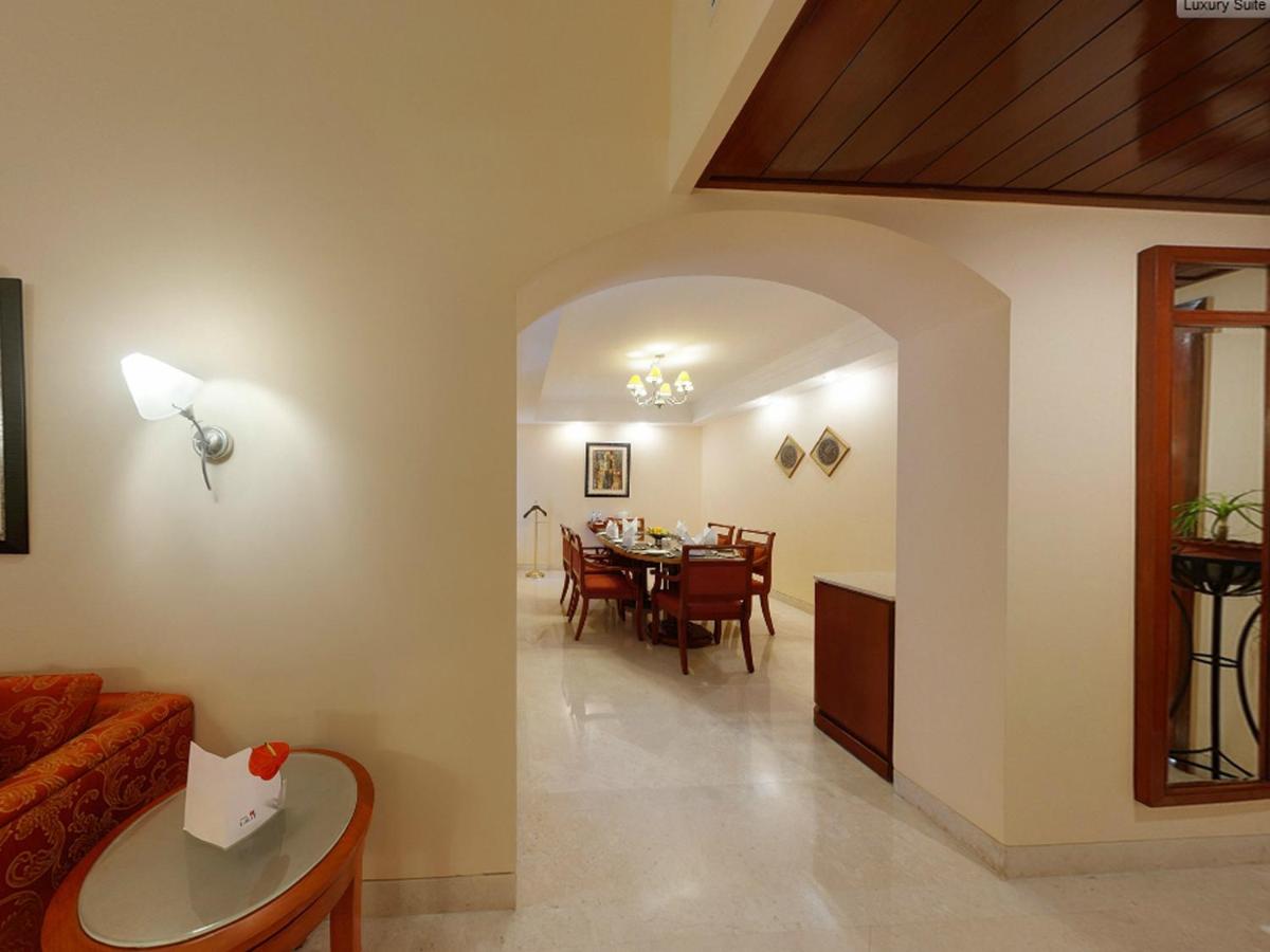 a living room with a couch and a table at The Lalit Ashok in Bengaluru a living room with a couch and a table at The Lalit Ashok in Bengaluru