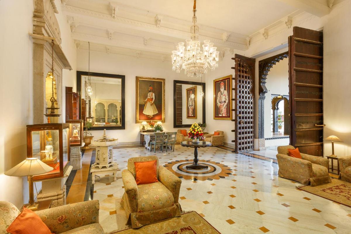a large living room with a chandelier and furniture at Shiv Niwas Palace by HRH Group of Hotels in Udaipur