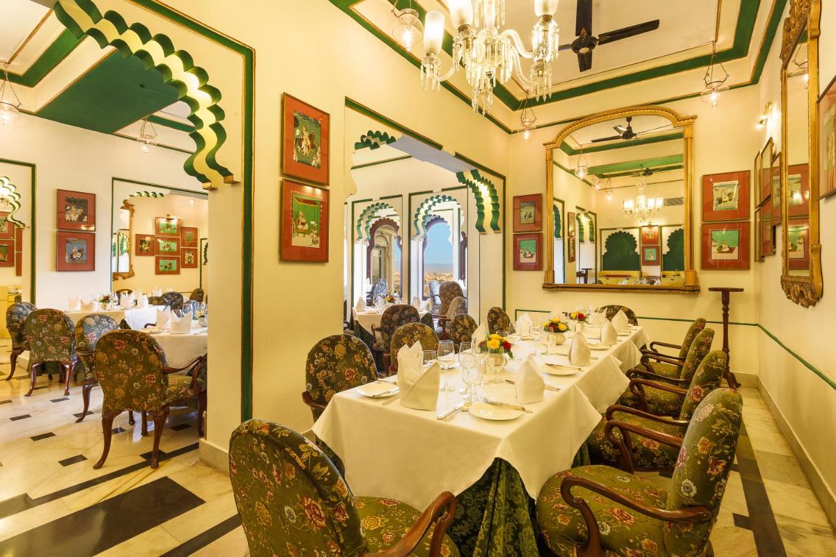 a dining room with tables and chairs in a restaurant at Shiv Niwas Palace by HRH Group of Hotels in Udaipur