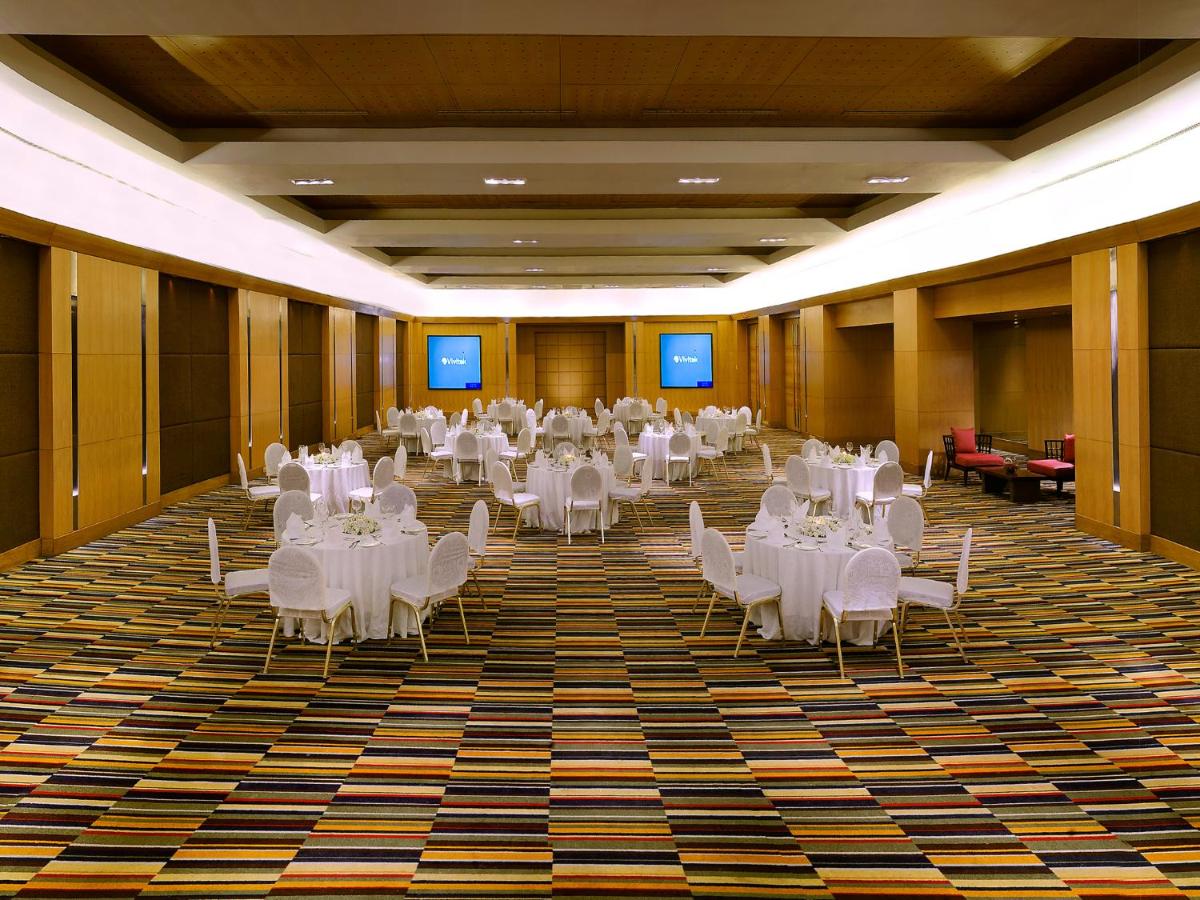 a large banquet hall with white tables and chairs at The Lalit Ashok in Bengaluru +89 photos a large banquet hall with white tables and chairs at The Lalit Ashok in Bengaluru +89 photos