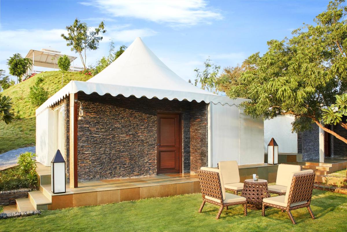 a white tent with chairs and a table in a yard at Taj Aravali Resort & Spa Udaipur in Udaipur