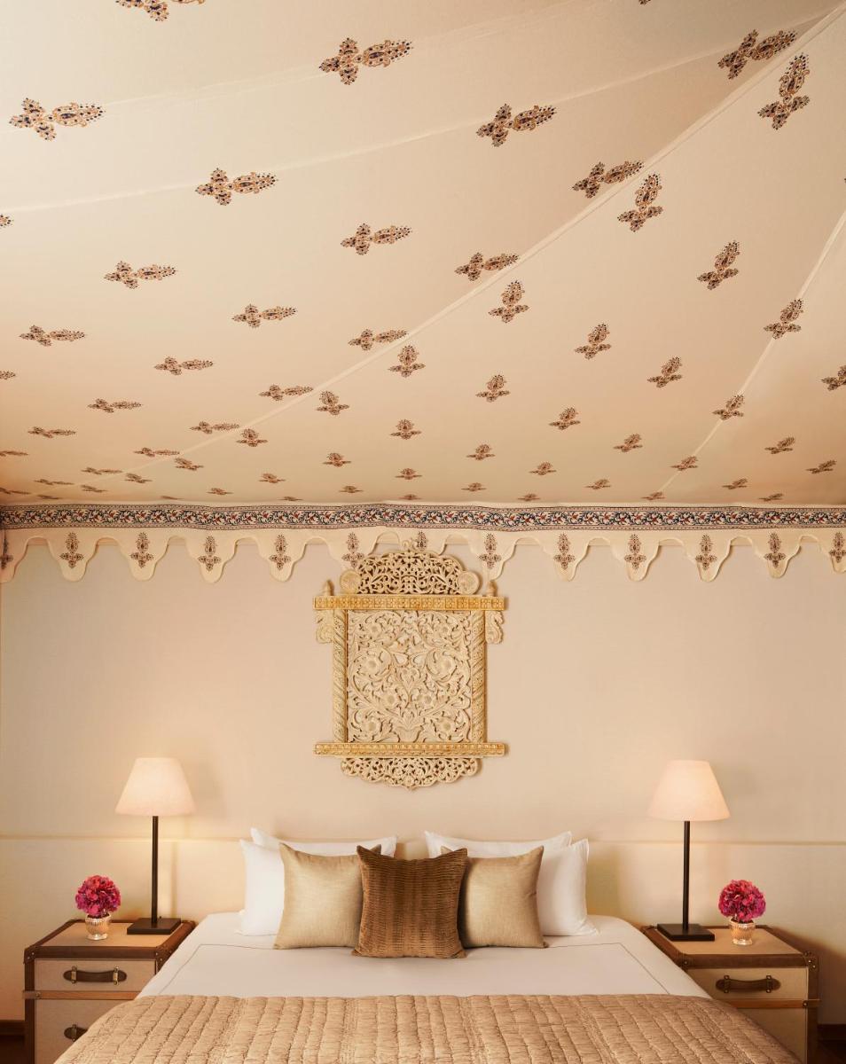 a bedroom with a king sized bed with ornate ceilings at Taj Aravali Resort & Spa Udaipur in Udaipur