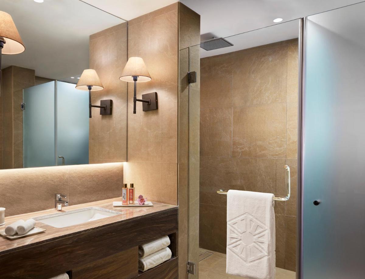 a bathroom with a sink and a shower at Taj Aravali Resort & Spa Udaipur in Udaipur