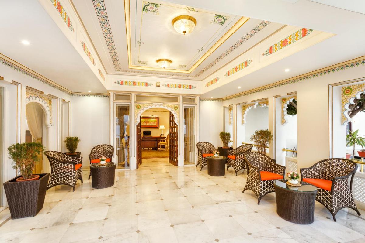a lobby with chairs and tables and a ceiling at Taj Fateh Prakash Palace Udaipur in Udaipur +63 photos