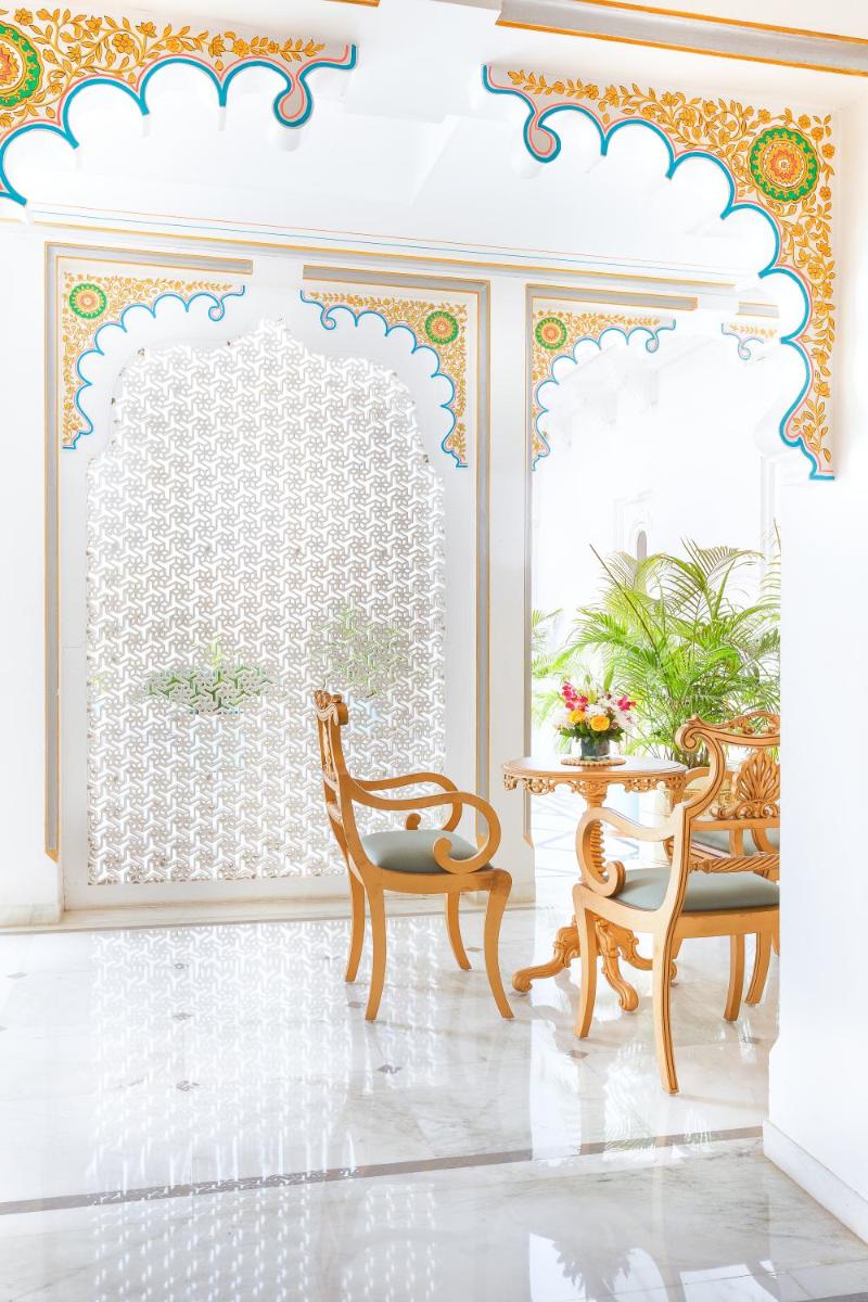 a room with two chairs and a table and a window at Taj Fateh Prakash Palace Udaipur in Udaipur
