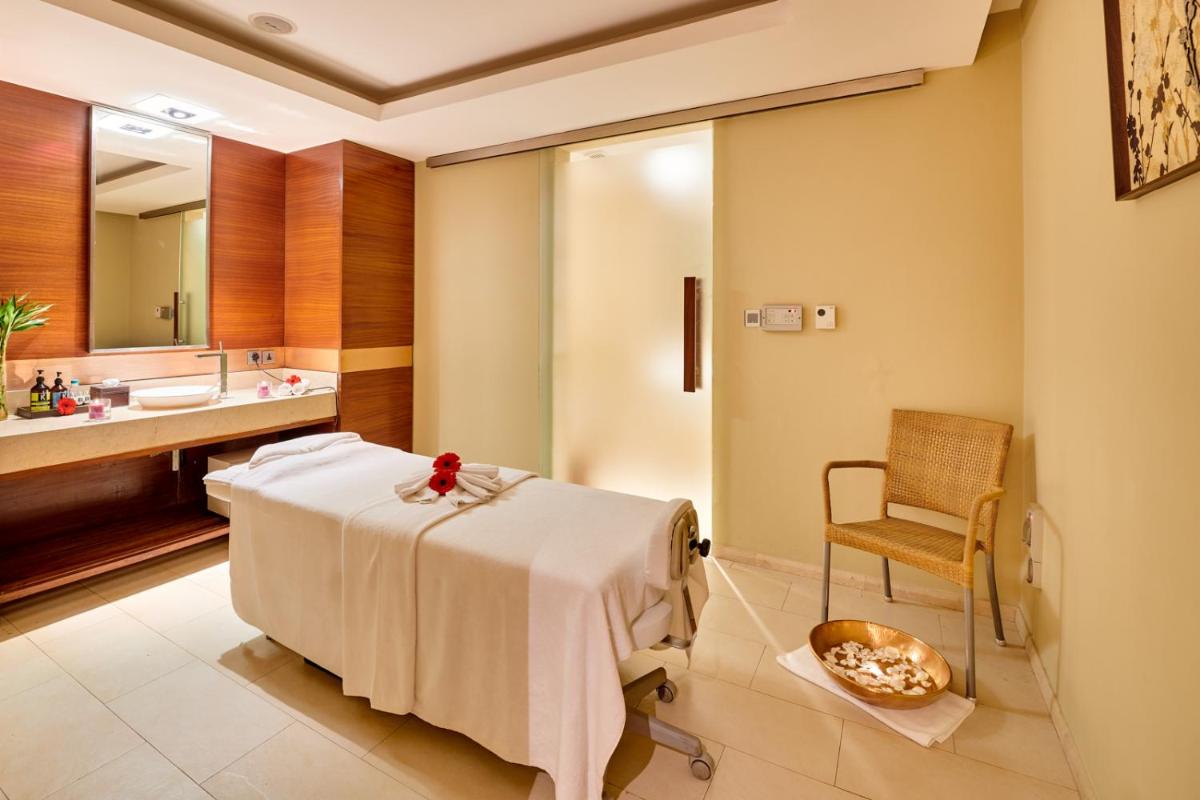 a hospital room with a bed and a sink at The LaLiT New Delhi in New Delhi