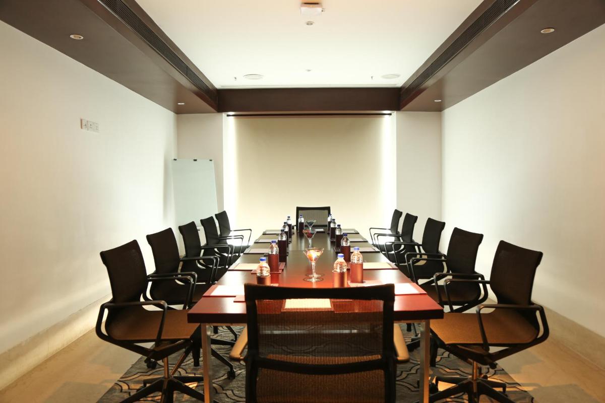 a conference room with a long table and chairs at Mercure Hyderabad KCP Banjara Hills, An Accor Hotel in Hyderabad