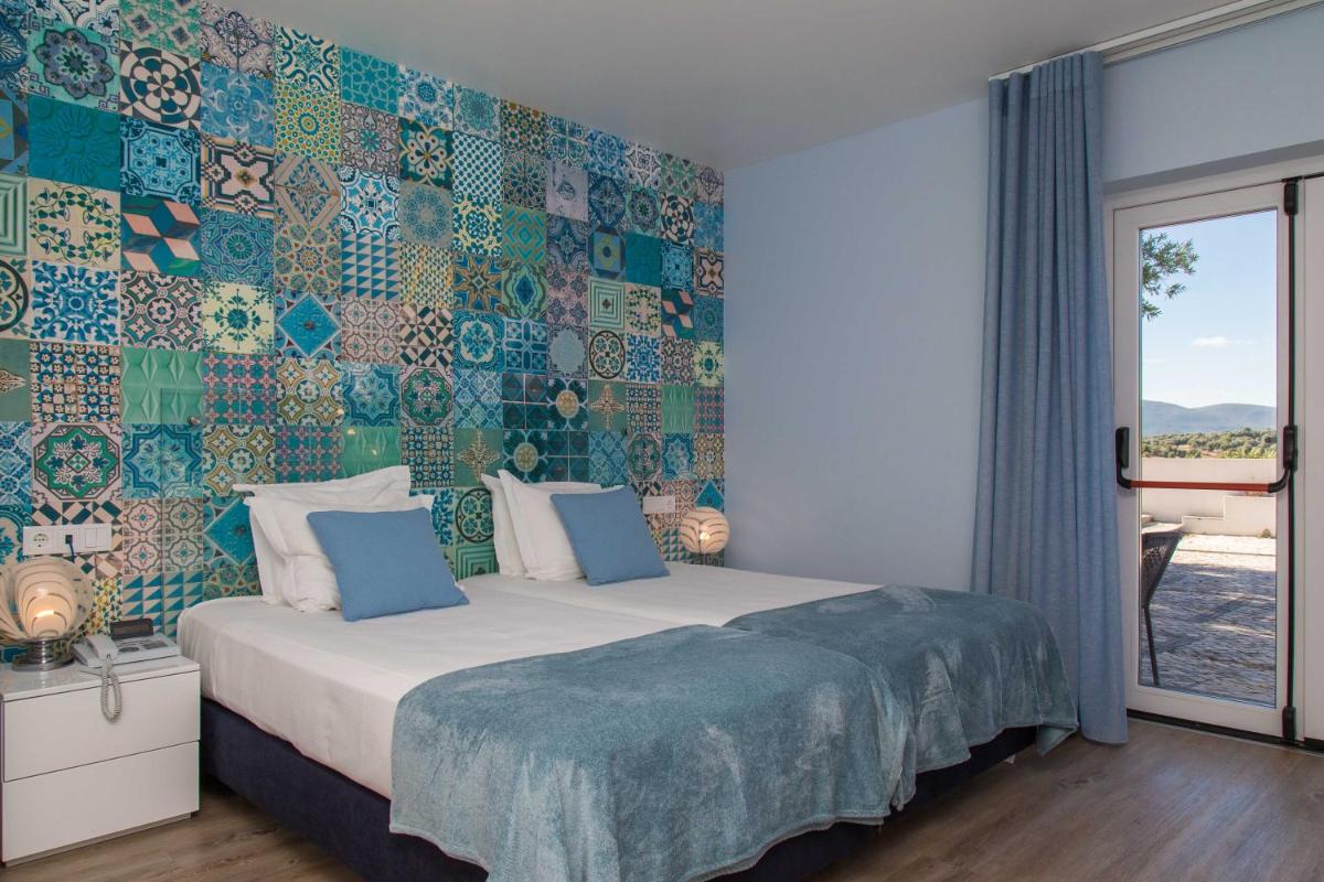 Uma cama ou camas num quarto em Aires da Serra Hotel