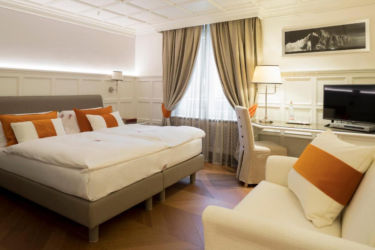 Un ou plusieurs lits dans un hébergement de l'établissement Grand Hôtel des Alpes