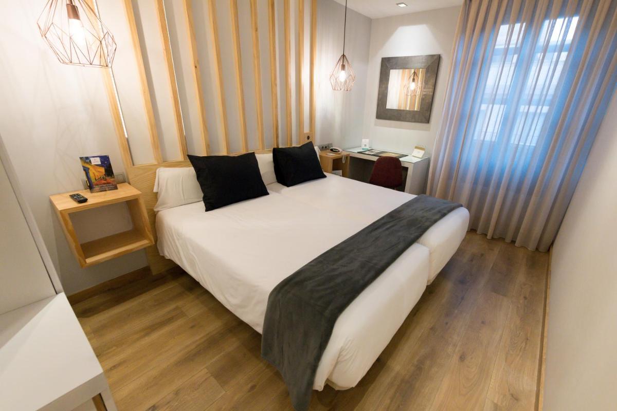 Cama o camas de una habitación en Hotel Fruela
