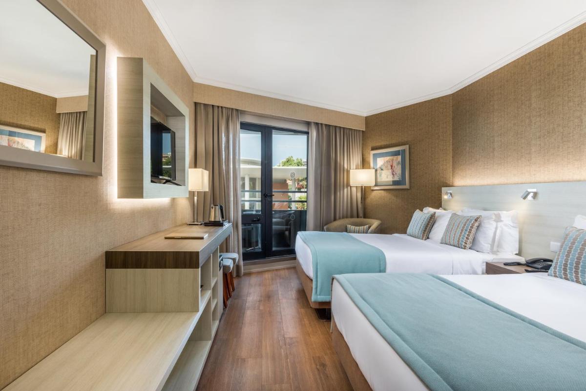 Uma cama ou camas num quarto em Enotel Lido - All Inclusive