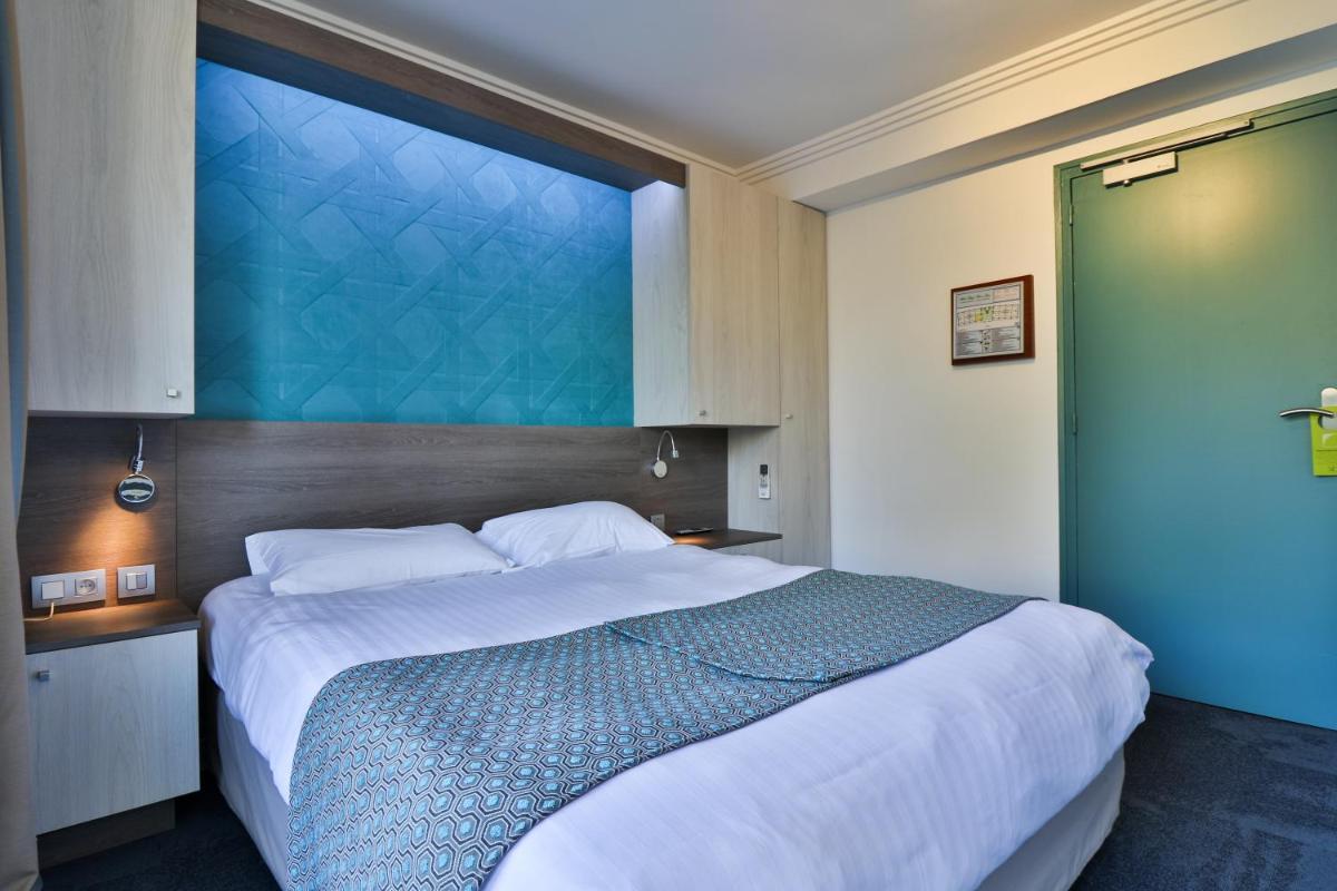 Un ou plusieurs lits dans un hébergement de l'établissement Hotel SPA Plage St Jean
