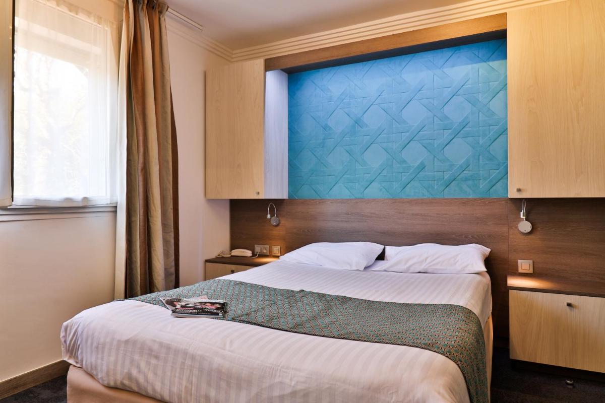 Un ou plusieurs lits dans un hébergement de l'établissement Hotel SPA Plage St Jean