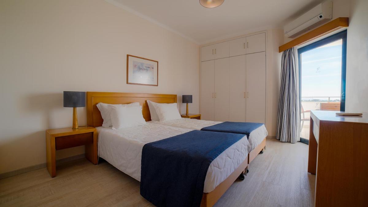 Uma cama ou camas num quarto em Vila Petra