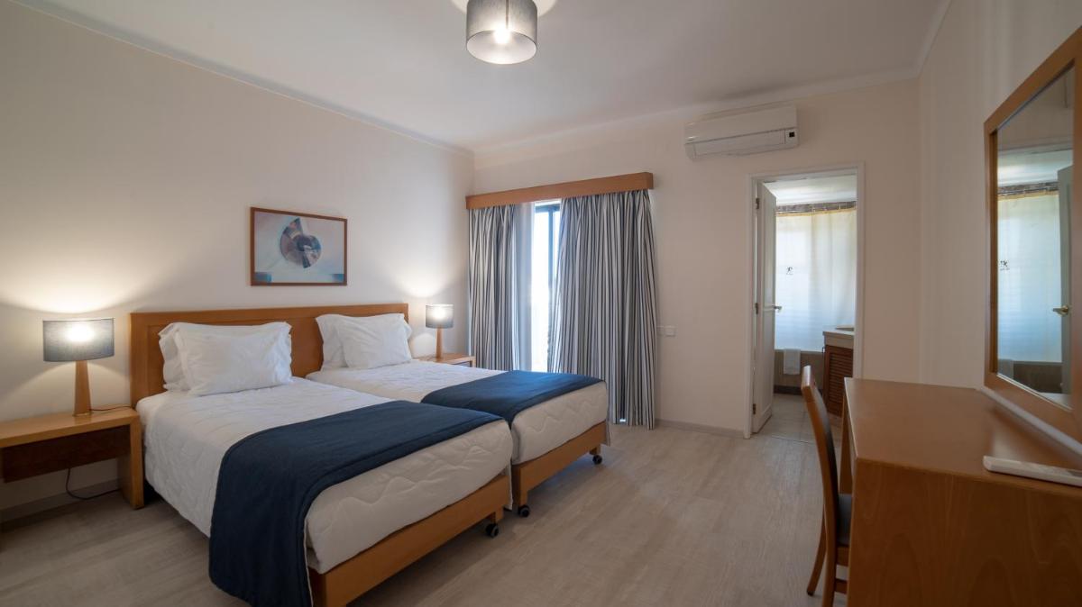 Uma cama ou camas num quarto em Vila Petra
