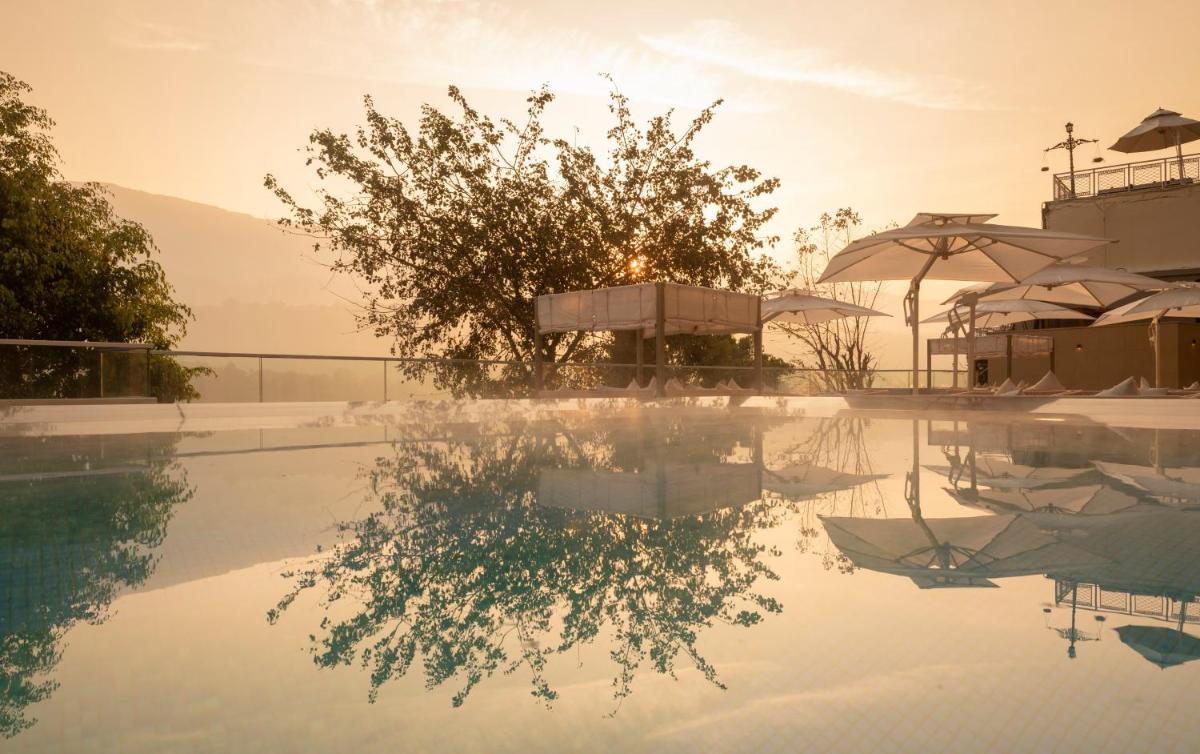a pool with a reflection in the water at Modi Yoga Retreat Rishikesh in Rishīkesh