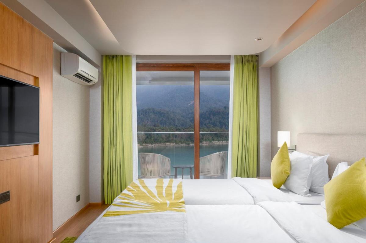 a bedroom with a large bed and a large window at Modi Yoga Retreat Rishikesh in Rishīkesh