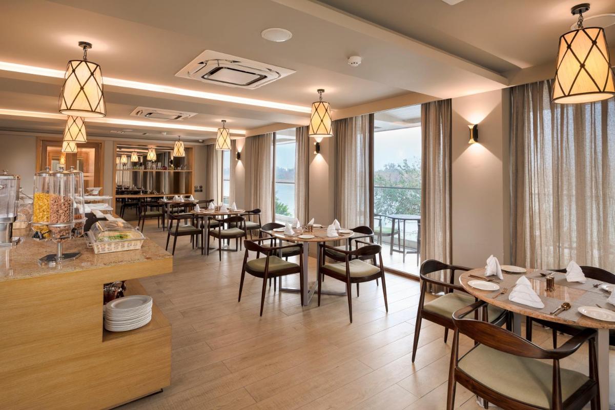 a restaurant with tables and chairs and a bar at Modi Yoga Retreat Rishikesh in Rishīkesh