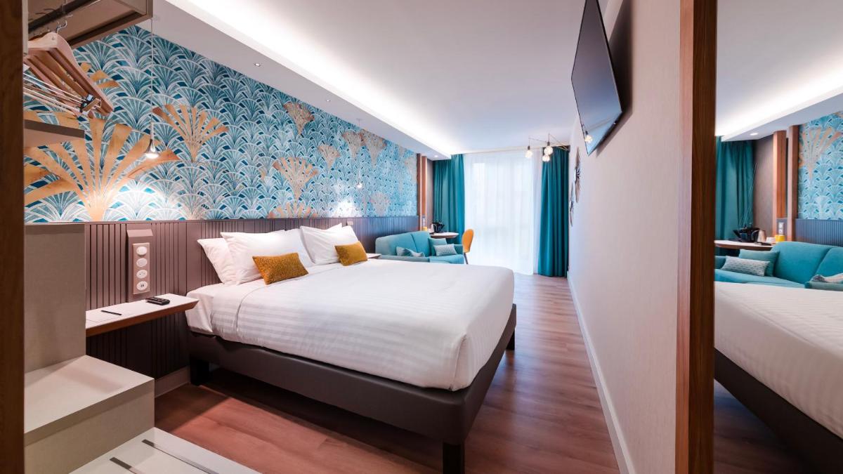 une chambre d'hôtel avec un grand lit et une chambre avec dans l'établissement voco Strasbourg Centre - The Garden by IHG, à Strasbourg