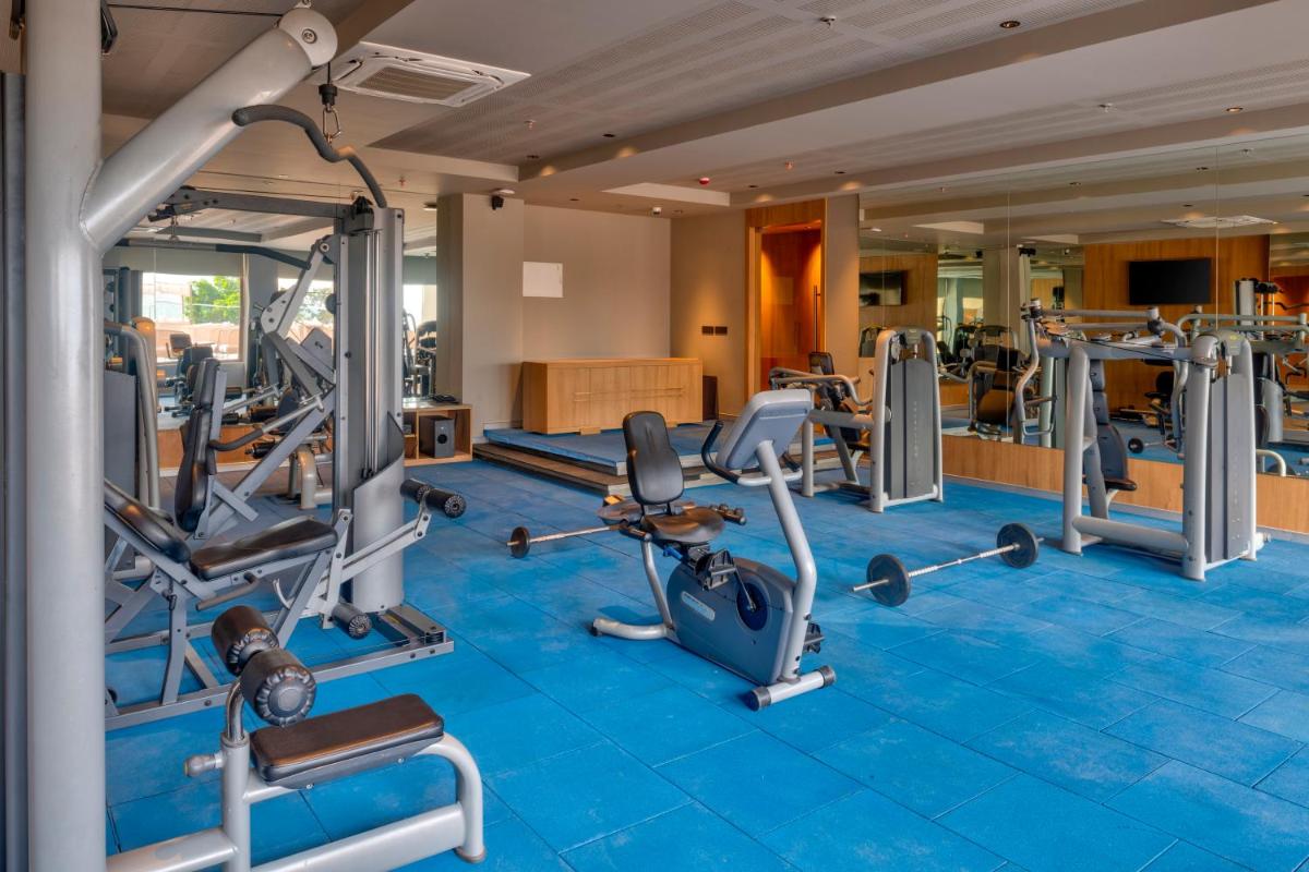 a gym with cardio equipment in a hotel room at Modi Yoga Retreat Rishikesh in Rishīkesh