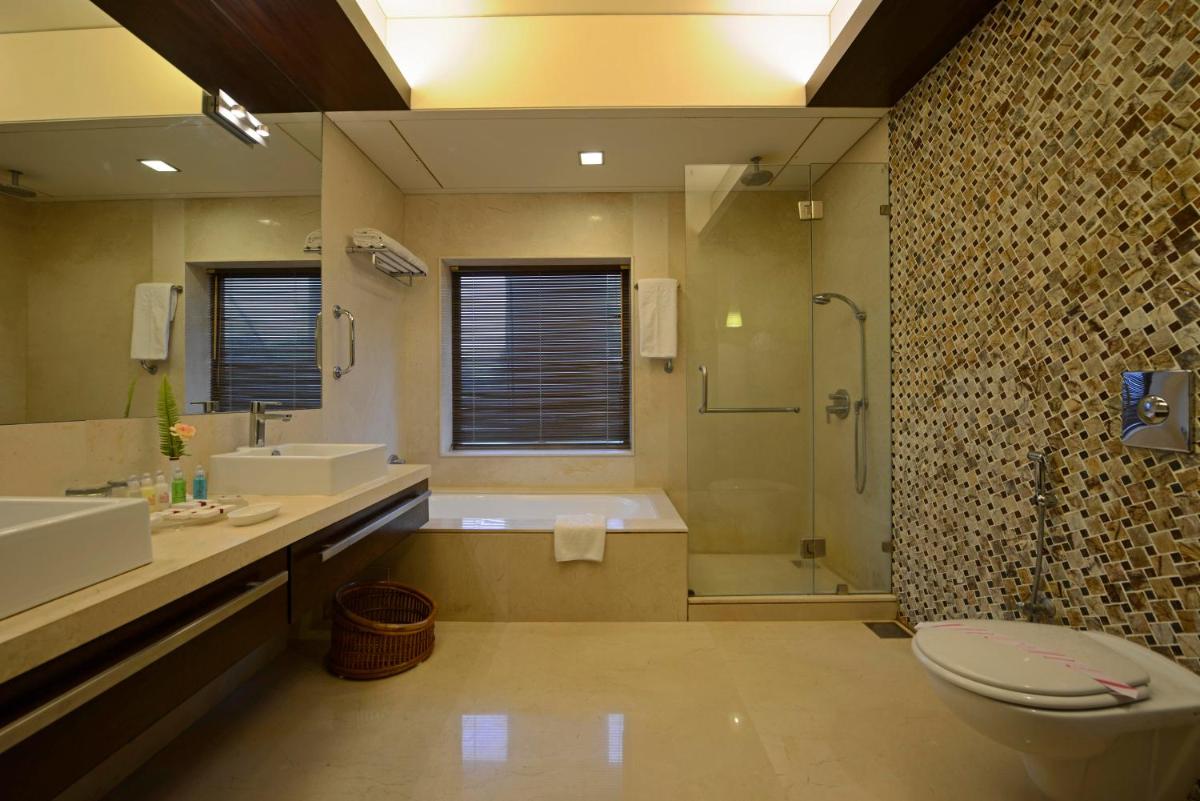 a bathroom with a tub and a toilet and a shower at Sun-n-Sand Mumbai Juhu Beach in Mumbai