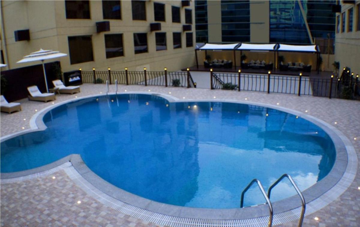 a large swimming pool in the middle of a building at Sterlings Mac Hotel in Bengaluru