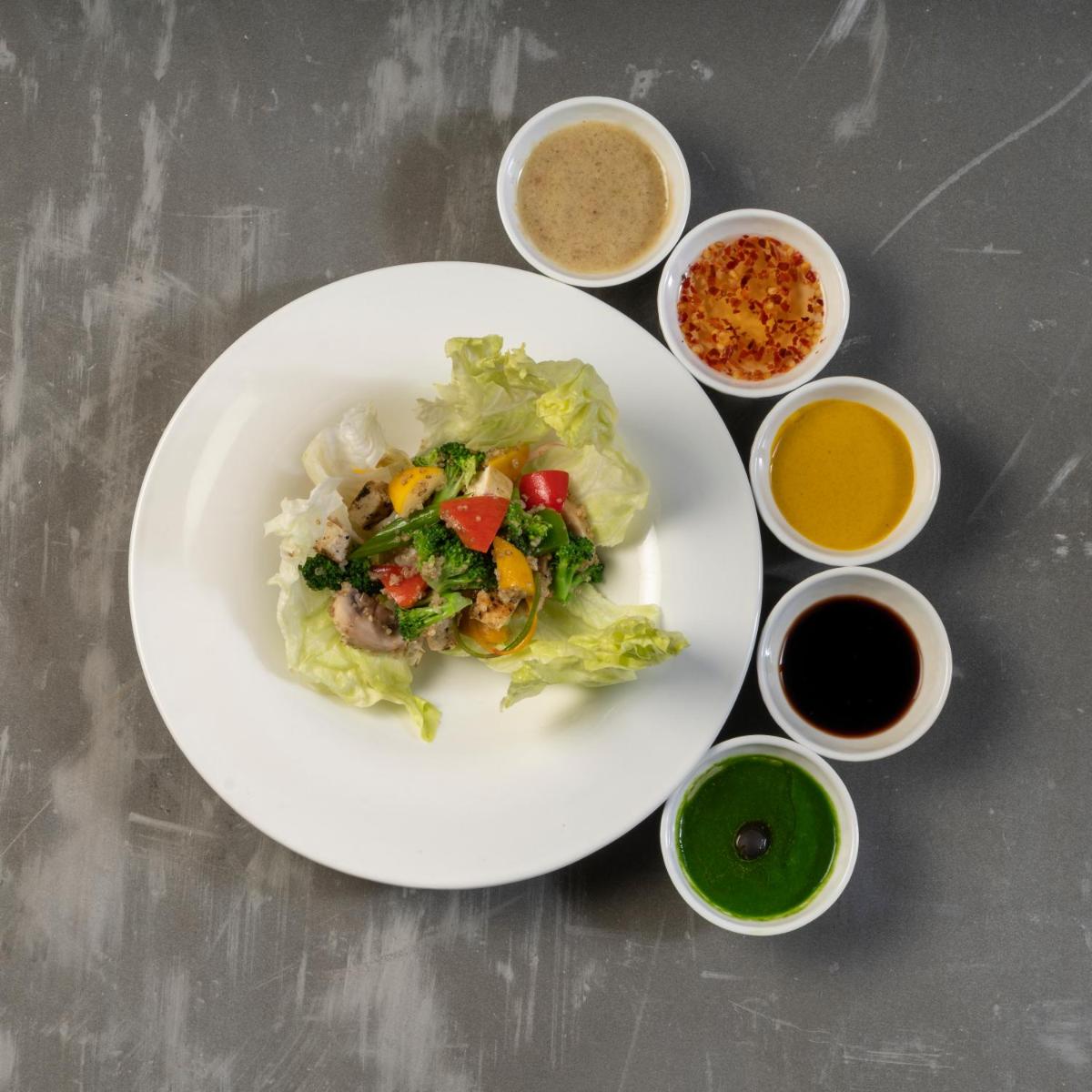 a white plate of food with vegetables and other ingredients at Modi Yoga Retreat Rishikesh in Rishīkesh