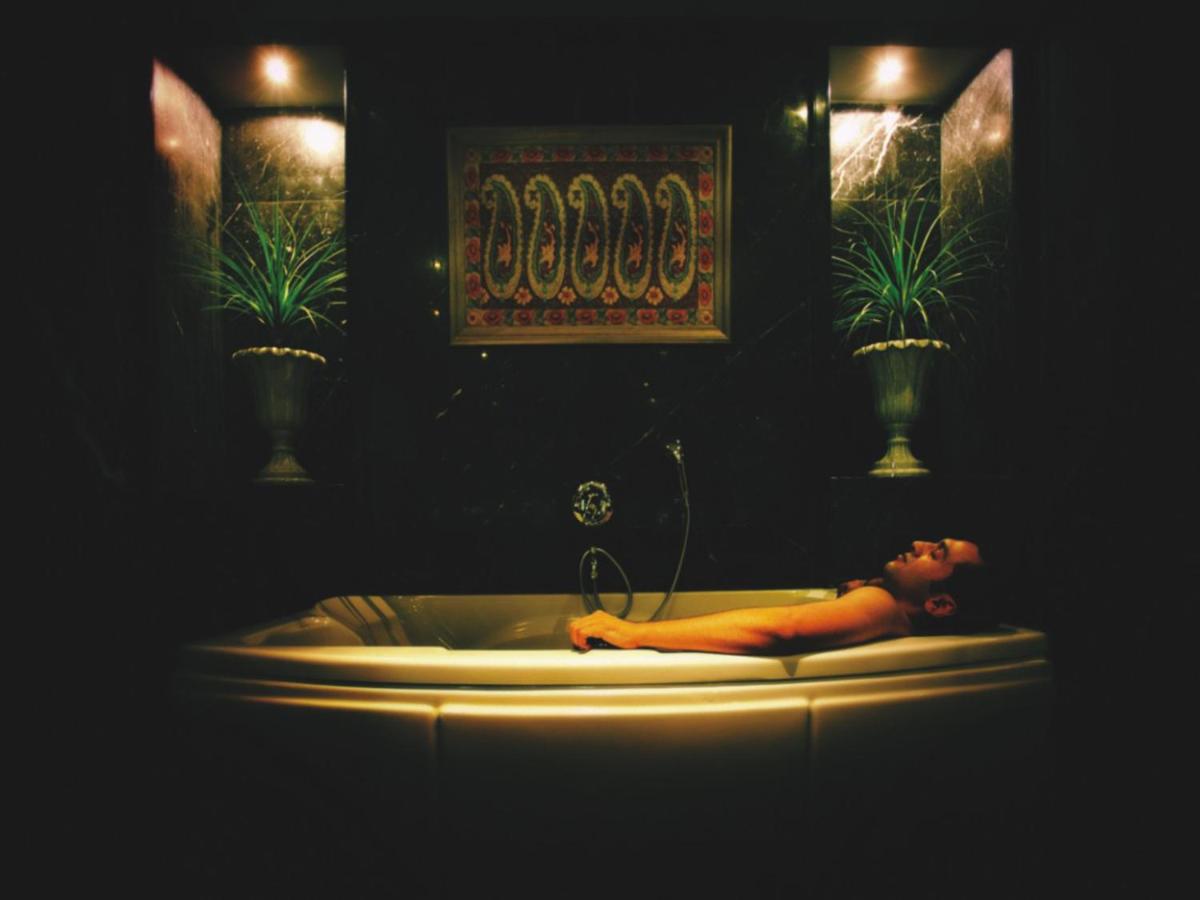 a woman laying in a tub in a bathroom at The Lalit Mumbai in Mumbai