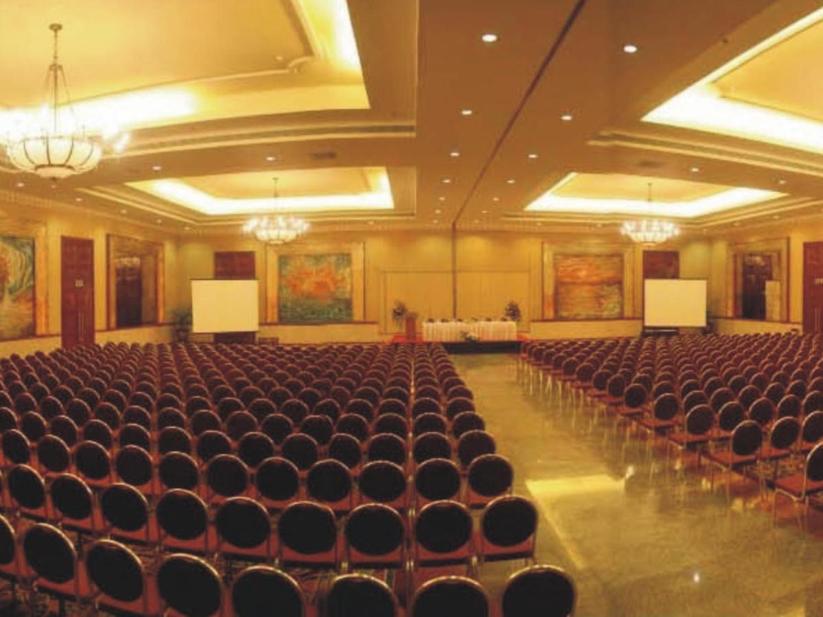 a large hall with chairs and tables in it at The Lalit Mumbai in Mumbai