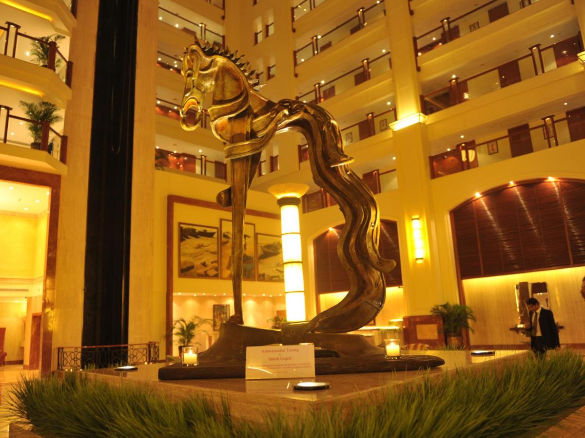 a bronze horse statue in front of a building at The Lalit Mumbai in Mumbai