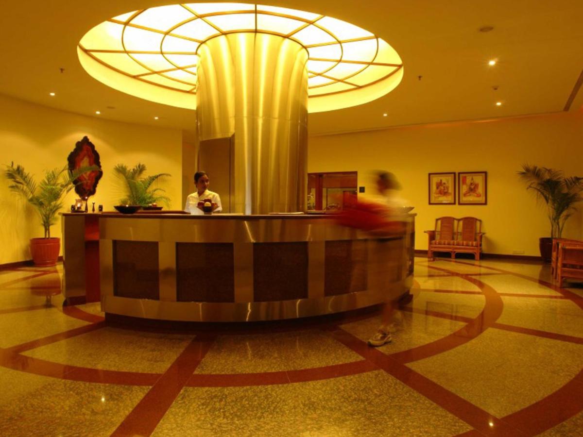 a lobby with a reception desk in a hotel at The Lalit Mumbai in Mumbai