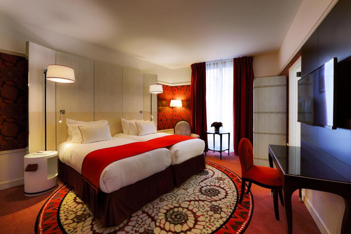 Un ou plusieurs lits dans un hébergement de l'établissement Carlton Hotel Lyon - MGallery Collection