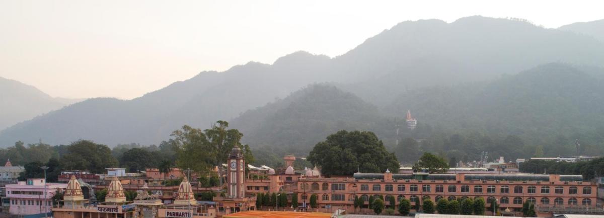 a view of a city with mountains in the background at Modi Yoga Retreat Rishikesh in Rishīkesh