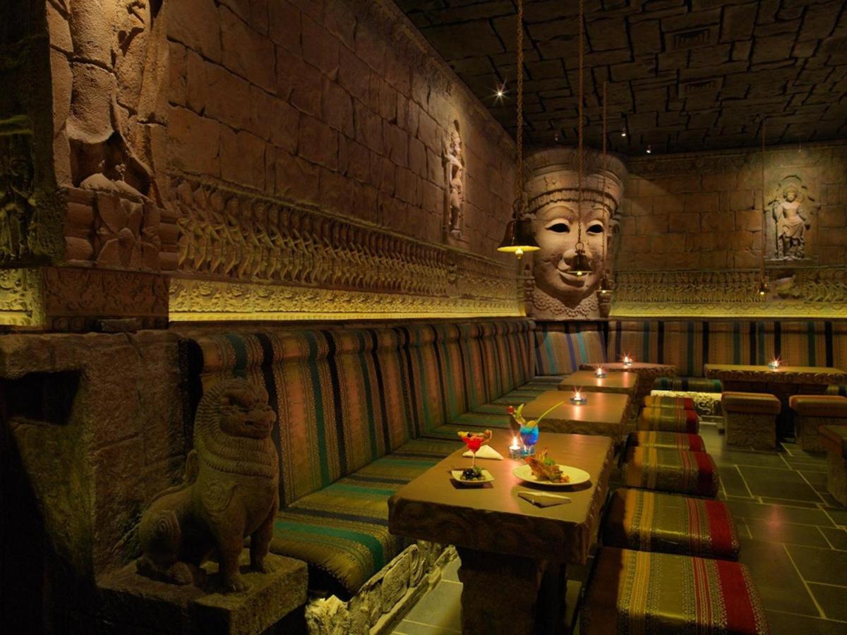 a restaurant with a large head on the wall at Sterlings Mac Hotel in Bengaluru