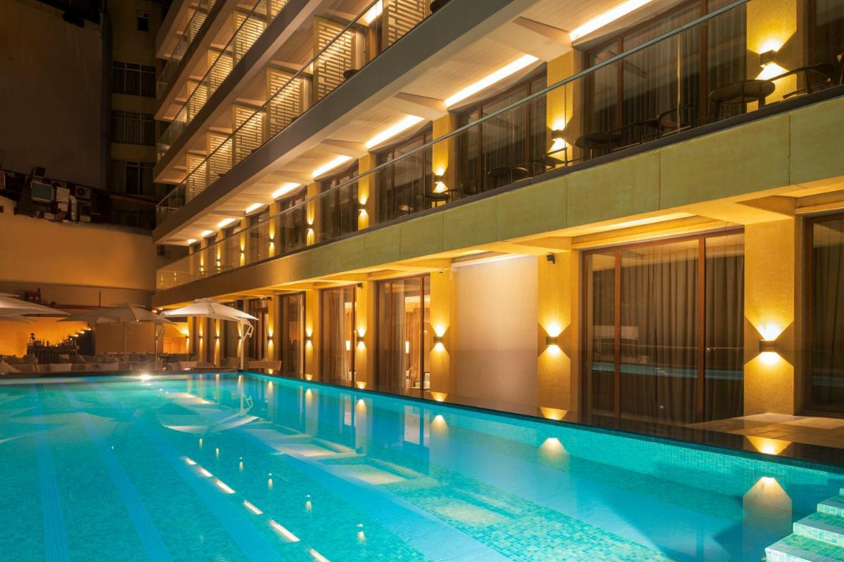 a large swimming pool in a building at night at Modi Yoga Retreat Rishikesh in Rishīkesh