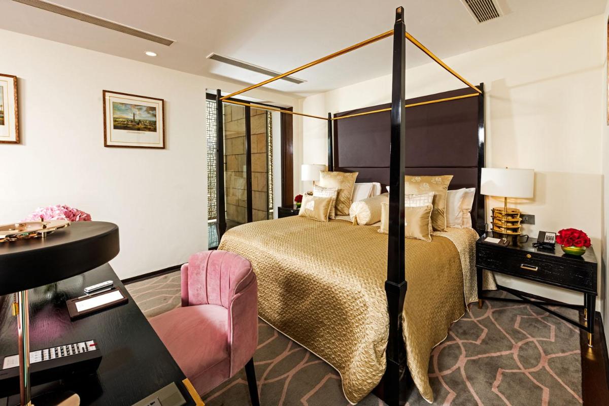 a hotel room with a bed and a desk at The Lodhi – A member of The Leading Hotels Of The World in New Delhi