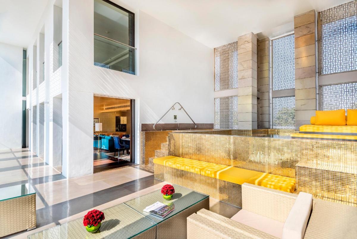 a living room with a couch and a table at The Lodhi – A member of The Leading Hotels Of The World in New Delhi