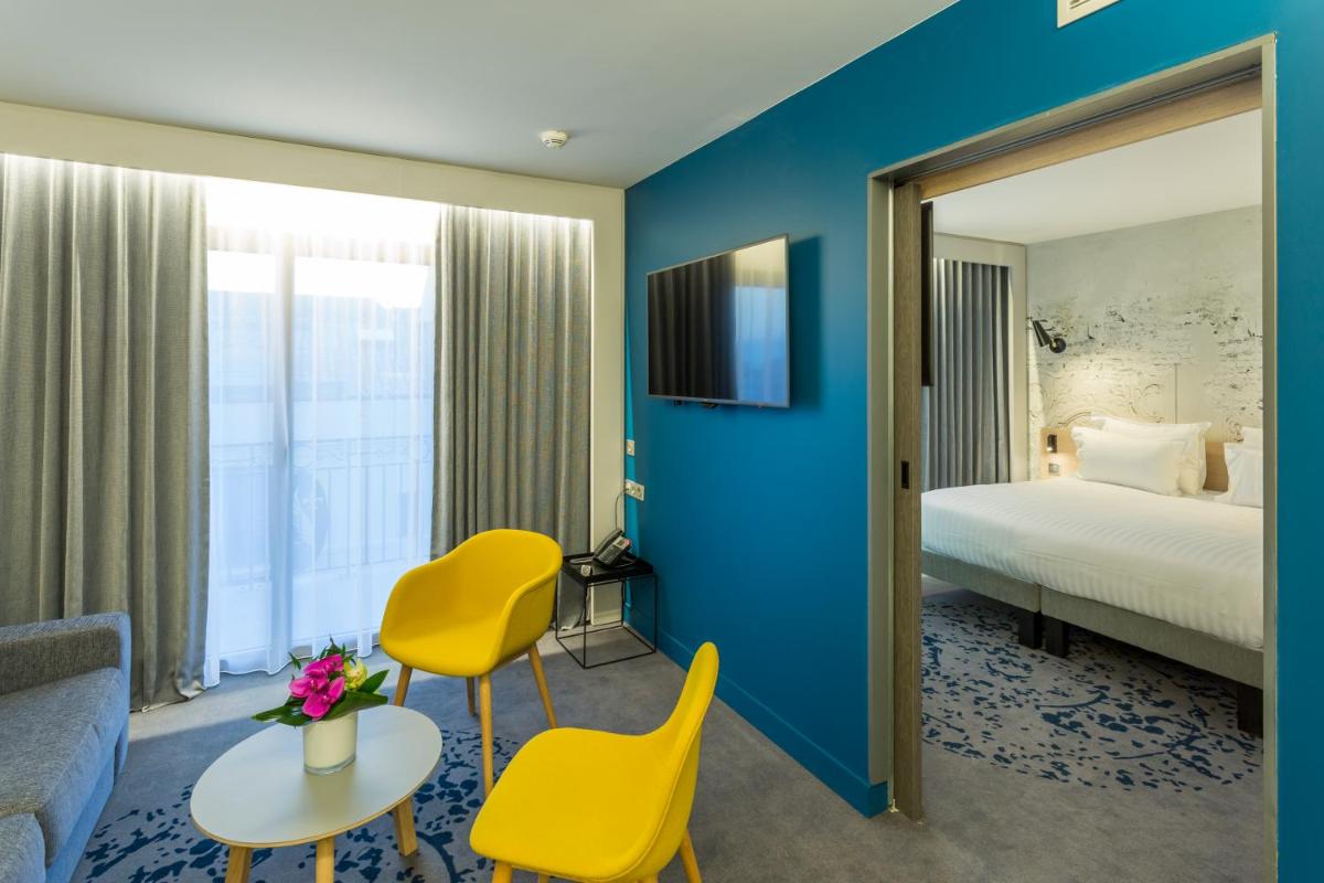Un ou plusieurs lits dans un hébergement de l'établissement Nemea Appart Hotel Cannes Palais