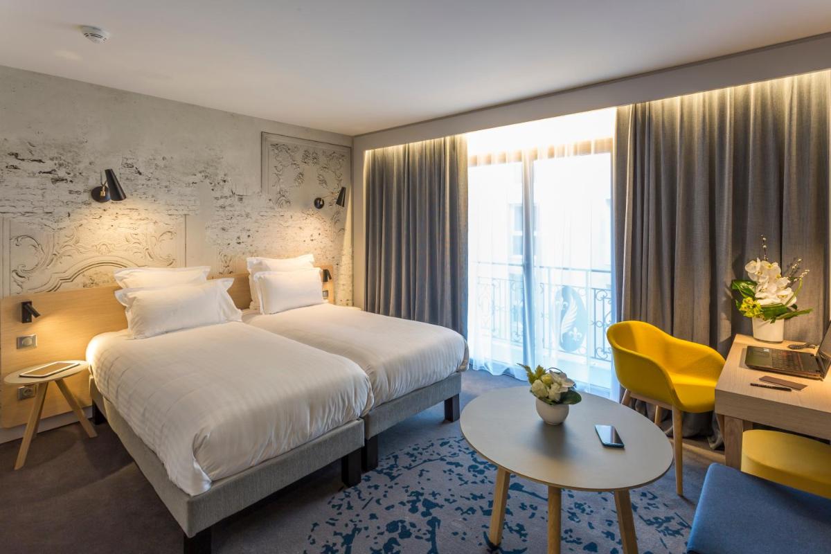 Un ou plusieurs lits dans un hébergement de l'établissement Nemea Appart Hotel Cannes Palais