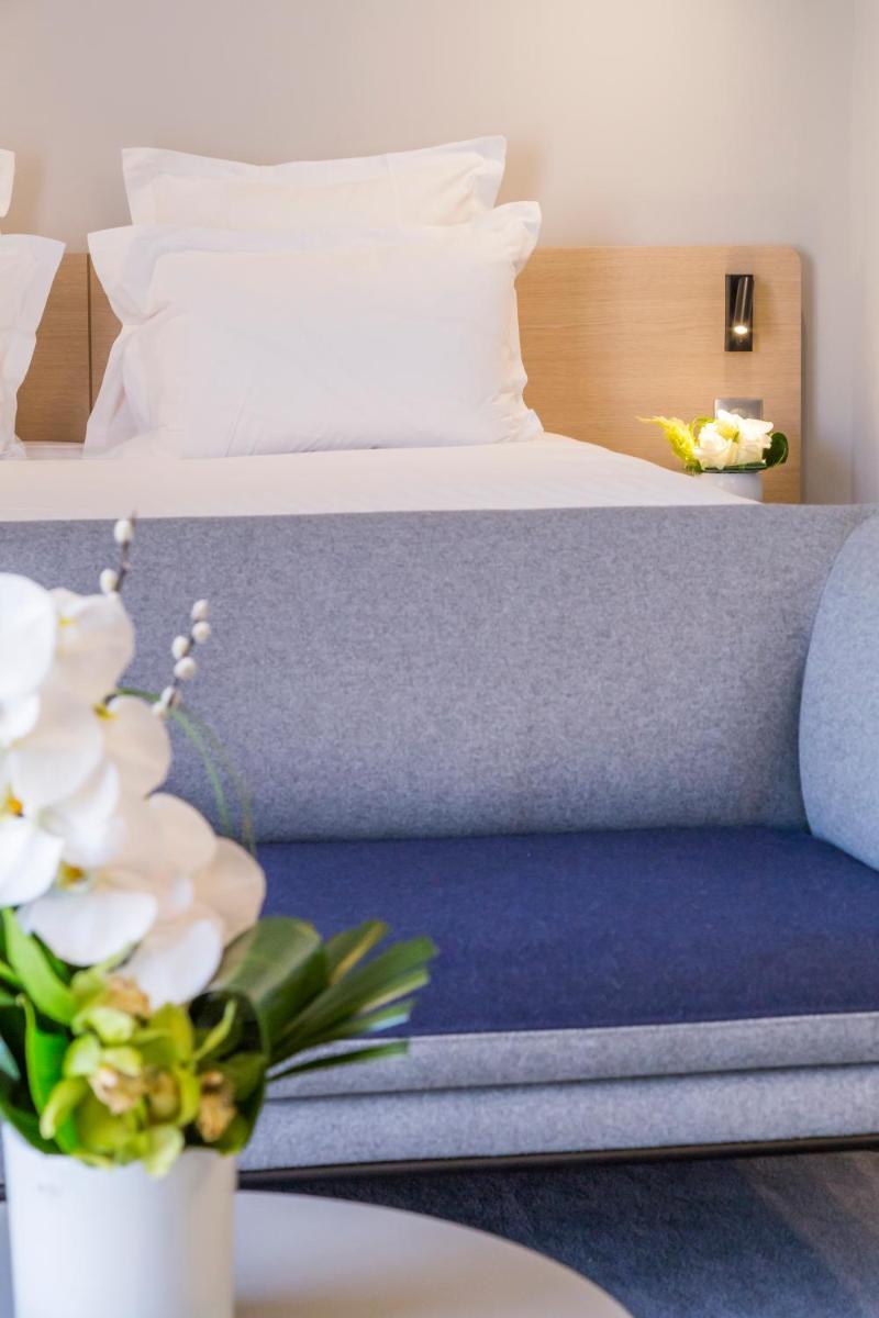 Un ou plusieurs lits dans un hébergement de l'établissement Nemea Appart Hotel Cannes Palais